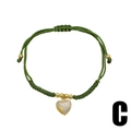 Bracciale in corda intrecciata verde con ciondolo a cuore dorato e cristalli - Verde (C)