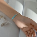 Detail of luxury silver bracelet with rectangular blue zircon stones and pavé diamonds - Single Row Light Blue