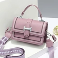 Elegant mauve crossbody bag with a wide geometric strap on modern geometric stands - Purple
