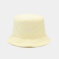 Macro detail of terry cloth texture and white embroidered logo on a yellow bucket hat - One Size / Light Yellow