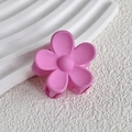 Close-up of matte pink flower hair claw clip on minimalist white wavy texture background - Fuschia
