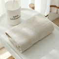Close-up of thick beige long-staple cotton towel neatly folded on a minimalist tabletop - 33*73CM / Off White