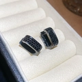Detailed close-up of square black zircon huggie earrings with micro-pave setting - Black