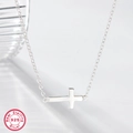 Detailed macro view of 925 sterling silver necklace showing side-ways cross pendant - White Gold