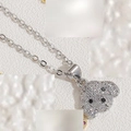 Macro detail of dog pendant necklace featuring sparkling cubic zirconia and black stone eyes - White Zirconia (Silver)