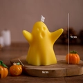 Yellow ghost-shaped scented candle in a warm Halloween scene measuring 9x8x6cm - Chubby Yellow (Lime Basil & Mandarin)
