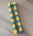Fidget wacky tracks sensory toy with 24 links in yellow and blue plastic on wood - Yellow Blue