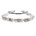 Detailed shot of white turquoise beads with stainless steel accents on a braided cord - White Turquoise