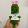 Detail of hand-knitted emotional support pickle with bow and encouraging card - Pickle With Large Bow