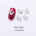 Close-up of 7.5x10mm silver hollow butterfly nail charms on a deep red manicure base - Silver Textured Butterfly (8805)