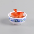 Miniature roasted chicken food model in a blue and white porcelain style ceramic bowl - Roasted Chicken