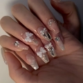 Close-up of nude gradient press-on nails with 3D white bows and sparkly rhinestones - By1564 Silver Pink White Collar / Glue Type