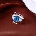 Detail of vintage resin eye ring with irregular silver lava frame on dark fabric - Silver