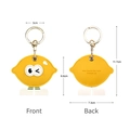Yellow lemon PU leather AirTag case featuring cute cartoon eyes and golden keychain - Lemon Big Eye
