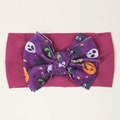 Detailed view of kids Halloween headband with purple pumpkin ghost bow on pink fabric - Deep Purple