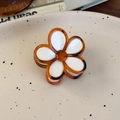 Detailed close-up of amber flower hair claw clip with white petals and resin finish - White Flower Small