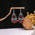 Macro detail of Bohemian silver metal drop earrings with intricate carving and red beads - E4339-2 Red Carved Teardrop