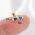 Blue heart cartilage earring in gold plating on finger showing 0.44cm x 1.0cm dimensions - Gold-Blue Heart
