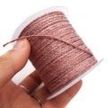 Close-up of pink-brown braided cord on a white plastic spool for jewelry making - Approx. 2.0mm / Pink Brown
