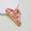 Macro detail of large hair claw clip featuring pink marble texture and smooth cream teeth - 10.7cm Semicircle / Pink White Marble