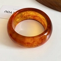 Amber wide resin bangle featuring natural smoke swirl patterns and artistic design - Amber