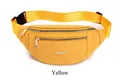 Detailed macro view of yellow water-resistant PU waist bag with gold metal dual zippers - Orange