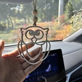 Detailed view of hand-carved owl wooden car pendant with rustic beads and hemp rope - Owl