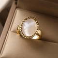 Macro view of 18K gold plated ring with white shell inlay and twisted rope edge details - 13712-Oval Braided Edge Mother of Pearl