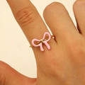 Close-up of pink enamel bow ring with 18K gold plated stainless steel band for women - Pink Enamel Bow Style (6959)