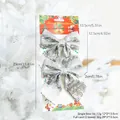 Set of two silver glitter Christmas bows with festive packaging on a white tree - 2 Pack Silver