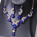 Detail of luxury bridal jewelry set with navy blue crystals and gold-tone finish - Necklace and Earring Set / Gold/Blue/White