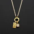 Stainless steel necklace with letter M and rhinestone pendants in 14K gold finish. - Letter M (XNL0116)