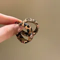 Dettaglio di piccoli orecchini a cerchio leopardati in resina marrone e nera - 2# Caffè - Cerchio Leopardato (3mm)