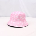Detail shot of a pink sun hat featuring white skull prints and decorative BOO lettering - One Size / Pink