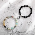 Close-up of heart-shaped magnetic clasp on natural tiger eye and matte bead bracelets - Amazonite Black Matte Heart B&W