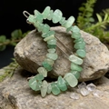 Detailed view of natural green crystal chips on a moon-shaped hair clip for women - Green Aventurine