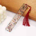 Detail of transparent acrylic rectangle bookmark with red tassels and colorful sequins - Dark Red