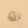 Macro detail of teardrop crystal earrings featuring silver settings on a beige background - White Zirconia (Silver)
