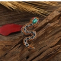 Close-up of vintage snake brooch with colorful rhinestones on rustic wood and dry leaves - Full Rhinestone Small Snake