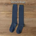 Classic JK uniform high calf socks in denim blue cotton knit on a wooden background - One Size / Blue