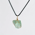 Detail of handcrafted green fluorite raw crystal pendant with gold wire wrapping - Green Aventurine