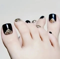 Press-on toenails featuring sleek black finish and sparkling gold glitter triangular accents - FW35
