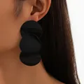 Minimalist geometric triple disc drop earrings in matte black on a side-view model - Black