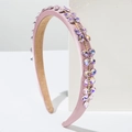 Detail of pink baroque headband with shimmering rhinestones on white geometric block - Pink