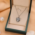 Icy silver leopard head necklace with green eyes and CZ diamonds on silk background - Silver