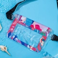 Waterproof phone pouch with colorful floral print and adjustable strap in water scene - Urban Beauty