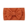 Soft orange brown nylon headband for babies featuring a large knitted bow design - Orange Brown