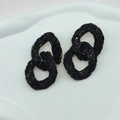 Detail of interlocking chain link earrings with micro-set black stones and gold accents - Black with Chain