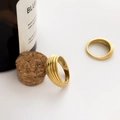 Detailed view of layered gold rings with elegant wave pattern texture on a minimalist base - US 7 / Multi-layer Style
