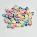 Macro detail of 10mm checkered heart-shaped polymer clay beads for DIY craft jewelry - Multicolor